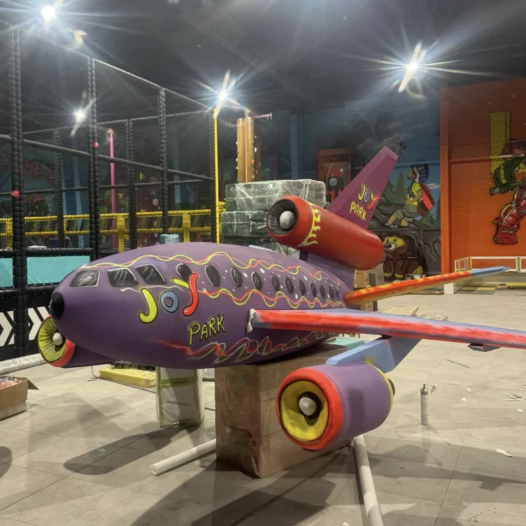 Purple custom aircraft sculpture for a themed indoor park