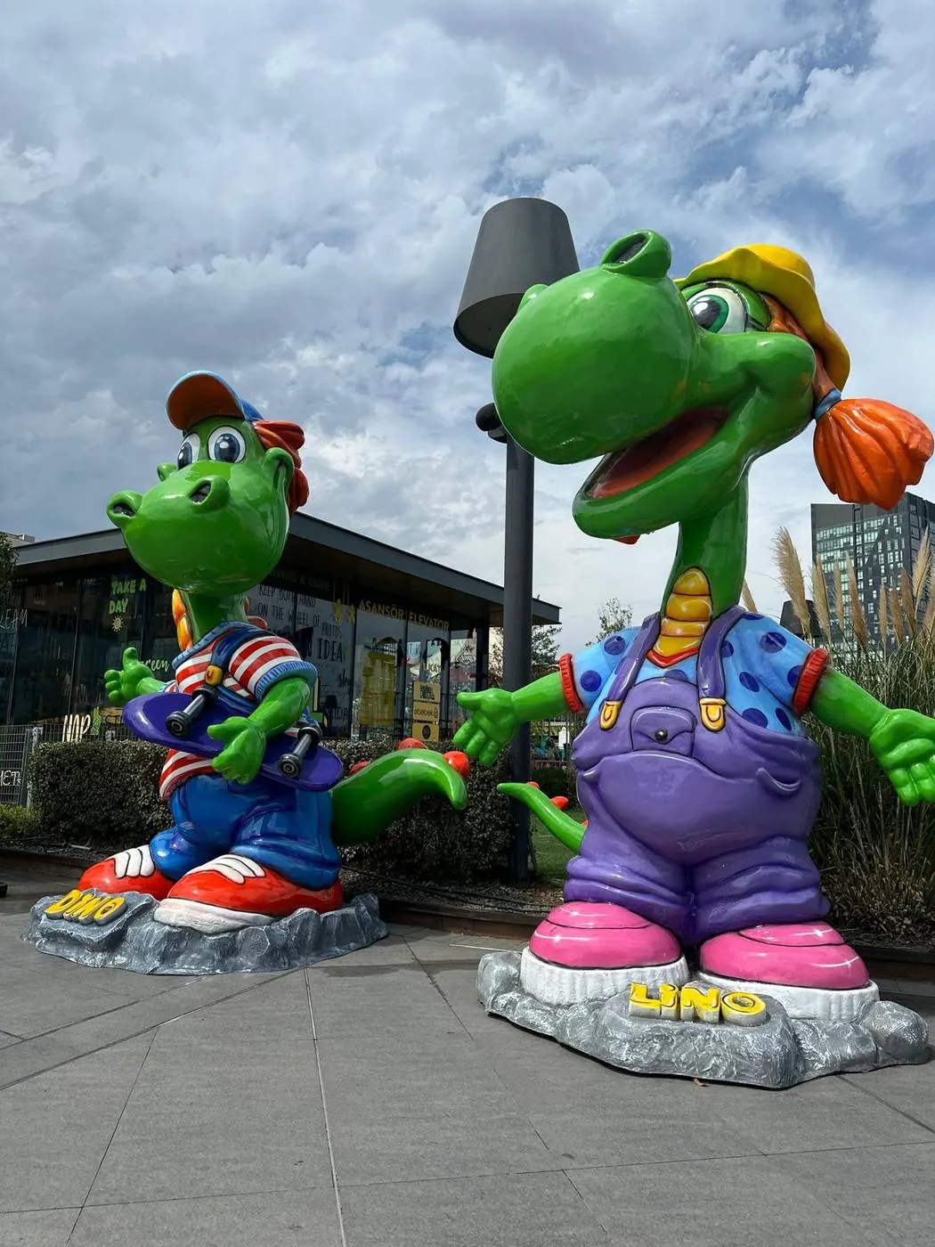 Oversized dinosaur mascots in shopping plaza