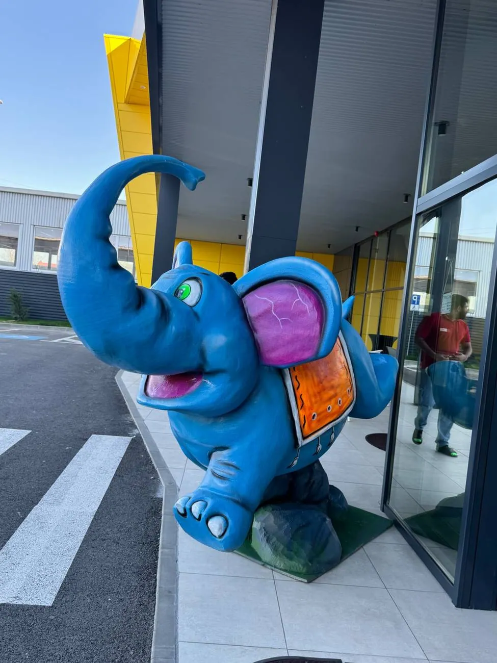 Oversized blue elephant sculpture displayed outside a venue